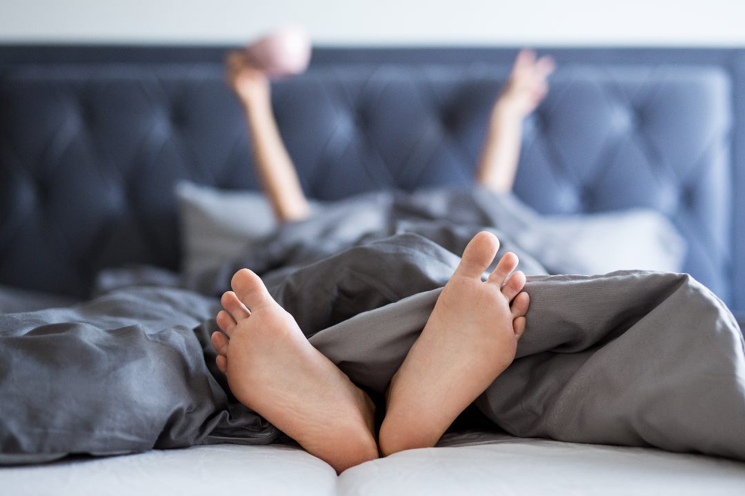 womans feet showing underneath weighted blanket